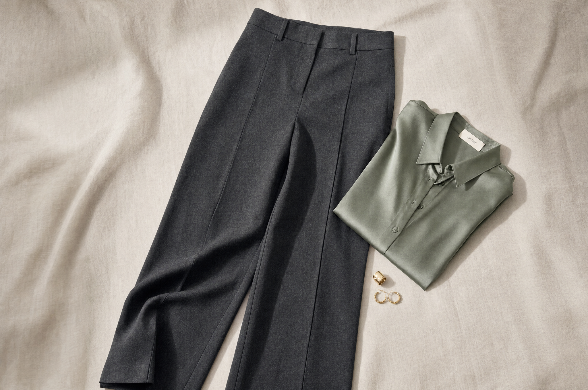 Wide-leg charcoal wool trousers styled with a sage silk blouse